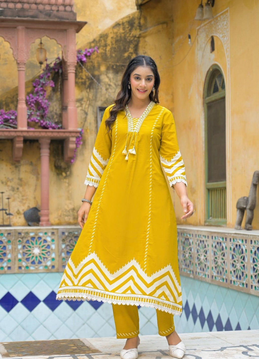 Mustard Yellow Cotton Suit Set with Ethnic Print with Lace & Tassel Detailing